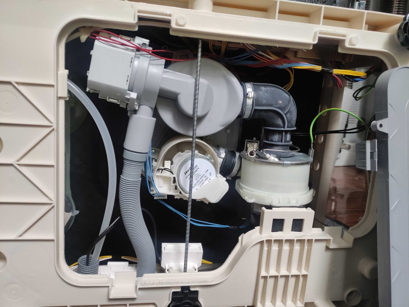 Dishwasher pump and internal components visible during repair diagnostics