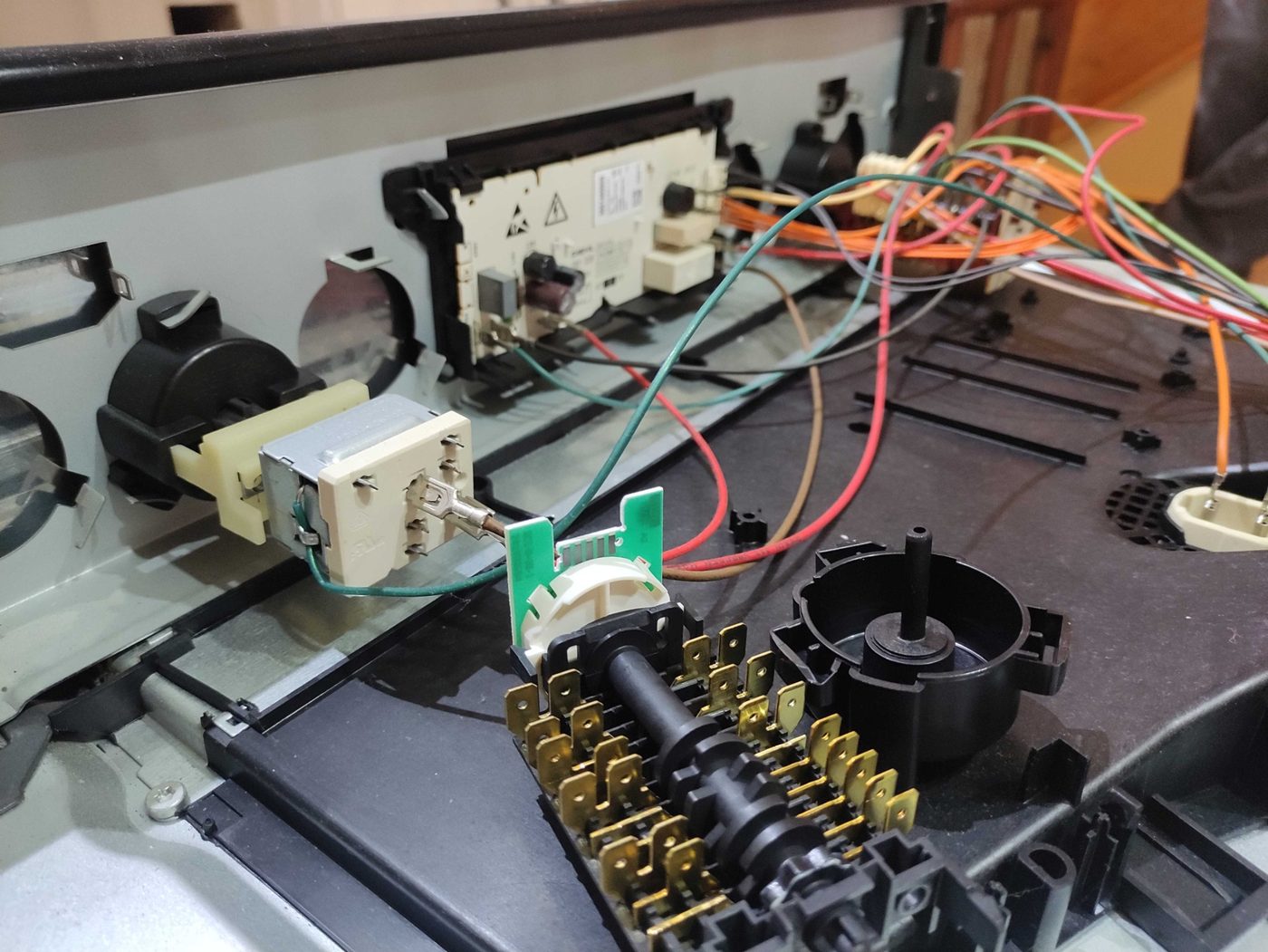 Electric oven selector switch and wiring exposed during repair